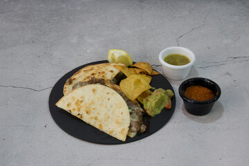 A plate of food with a taco and a side of chips
