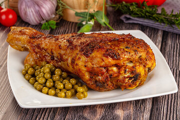 Baked turkey drumstick served green peas