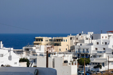 Whitewashed church and houses overlooking sparkling aegean sea in santorini, greece