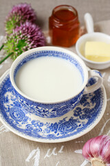 Porcelain China cup full of milk.