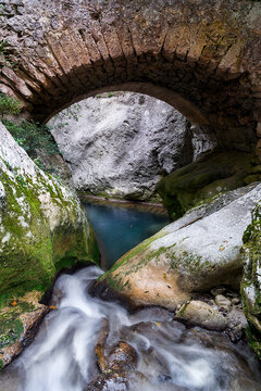 Small stone and brick bridge over the Puron River gorge