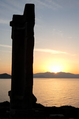 Portara of naxos overlooking the aegean sea and naxos town at sunset