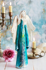 Beautiful blue figurine of an angel on the table.