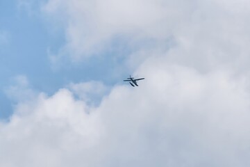 Seaplane flies in the blue sky, offering aerial tours of the island of Mauritius