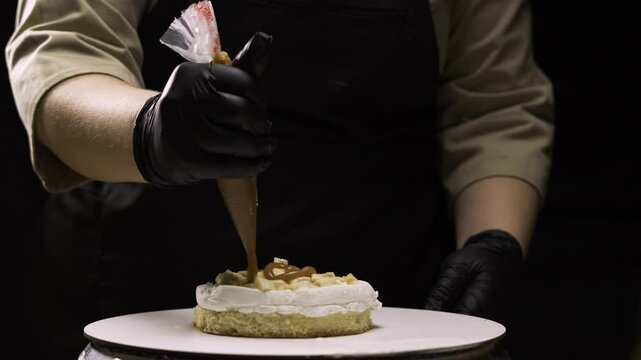 step by step process of making benta cake with banana filling. The pastry chef carefully pours a large amount of caramel into the filling from a pastry bag. step eight