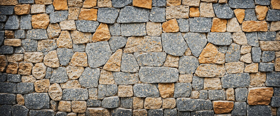 Rustic stone wall with a mix of gray, brown, and beige tones