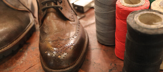 tip of handmade leather shoe in shoemakers workshop
