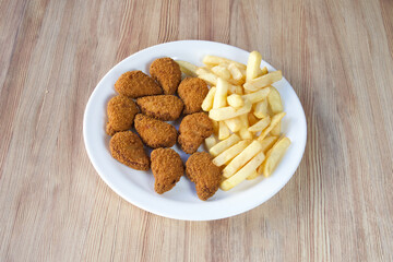 A plate of fried chicken nuggets and french fries