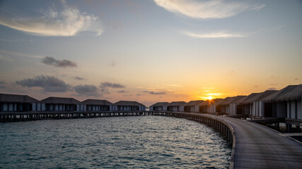 Fototapeta premium Water villas in the Maldives at sunrise