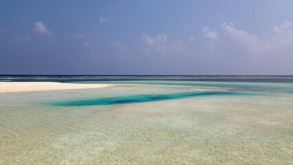 Sandy island on a Maldives atoll