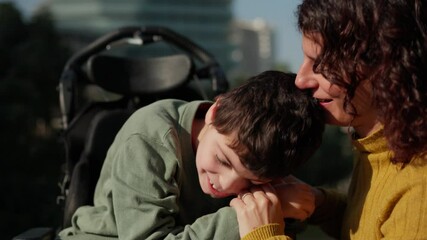 Loving mother taking care of disabled son in wheelchair
