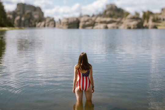 Woman in patriotic swimsuit standing in Sylvan Lake, SD