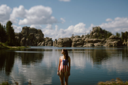 Woman in patriotic swimsuit standing in Sylvan Lake, SD
