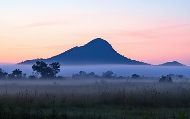Serene Sunrise Mountainscape with Morning Mist and Pink Sky