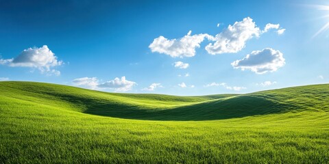 Fototapeta premium A hilly terrain covered in lush greenery under a bright blue sky, inviting exploration and adventure.