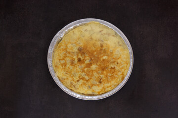 A pan of food with a brown crust and a golden center