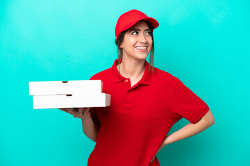 Pizza delivery woman with work uniform picking up pizza boxes isolated on blue background thinking...