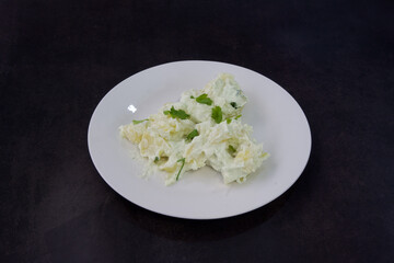 A plate of food with a green garnish on top