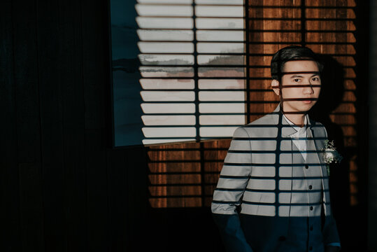 young man looking through window