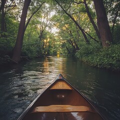 Fototapeta premium Serene river view from a canoe in lush greenery.