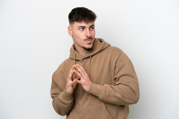 Young caucasian handsome man isolated on white background scheming something