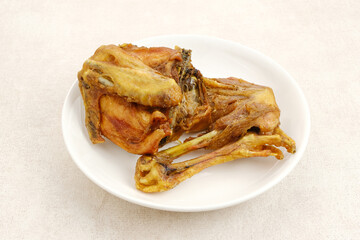 Ayam Goreng or Fried Chicken served on white plate, Indonesian food
