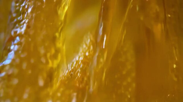 Close up Golden Liquid Flowing in Abstract Motion - Macro Photography