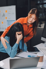 Asian women are stressed or has sore throat at office while working on laptop, Tired asian...