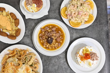 A table with a variety of food, including a cake