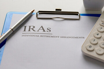 Individual Retirement Arrangement Form with Pen and Calculator – Financial Future Preparation