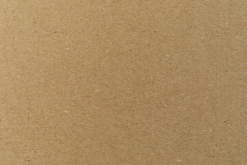 Close-up of recycled beige cardboard.  A sheet of pasteboard as a texture background.