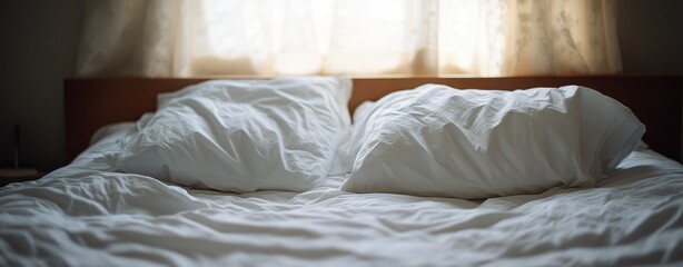 A cozy bedroom with a neatly made bed and soft pillows, inviting relaxation and comfort.