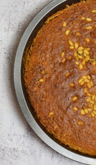 Zenith view and close up, homemade sponge cake with pine nuts and chocolate.