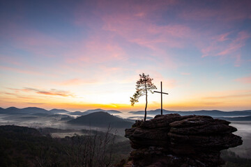 Summit cross on a sandstone rock in the middle of the forest. Landscape with a magnificent view...
