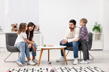 Overwhelmed parents and their hyperactive children at home