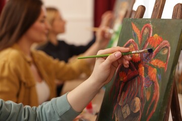 Women learning to draw in class, closeup