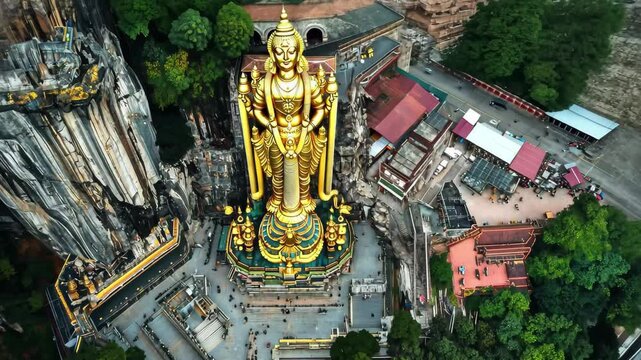 Explore the grandeur of Batu Caves and the towering statue of Murugan from an aerial perspective, Aerial view of Batu Caves And Gold statue Of Murugan In Kuala Lumpur, Malaysia