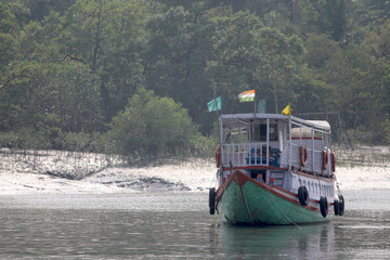 Tourist boat enjoying boat safari at Sundarbans Tiger Reserve. World's Largest Mangrove Forest & UNESCO WORLD HERITAGE CENTRE. © Sourav Mahata