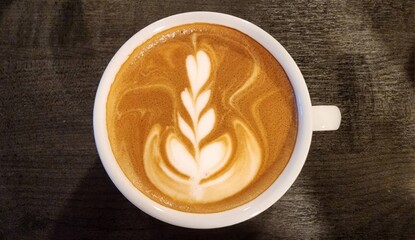 Beautiful Heart and Leaf Latte Art in a White Coffee Cup