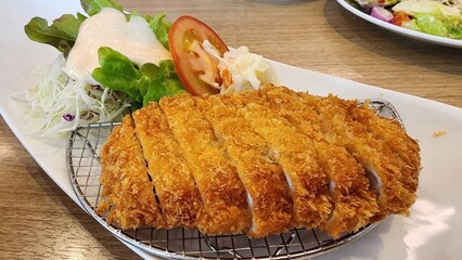 Crispy Breaded Chicken Cutlet with Fresh Salad and Tomato Slice