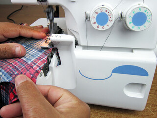 She works as a fashion designer (tailor).