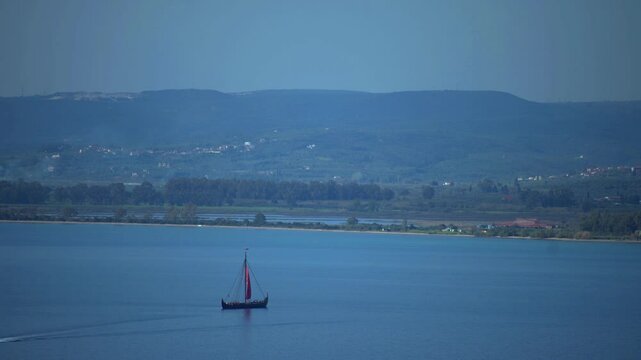 Greek trireme ancient rowed warship at calm blue sea