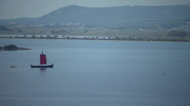 Greek trireme ancient rowed warship at calm blue sea
