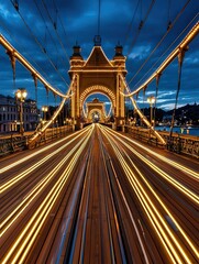 Obraz premium Stunning Cityscape at Dusk with Illuminated Suspension Bridge and Vibrant Light Trails, Showcasing Urban Night Life and Architectural Beauty