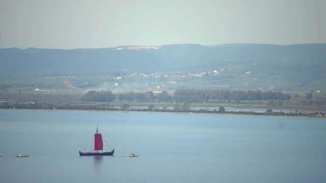 Greek trireme ancient rowed warship at calm blue sea
