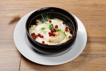 An exquisitely presented gourmet dish that showcases vibrant pomegranate seeds along with fresh microgreens