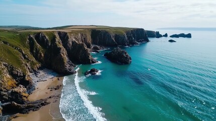 Obraz premium Aerial beach scene showing a rocky coastline, with turquoise waves crashing against jagged cliffs