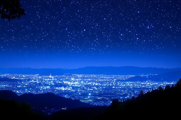 Fototapeta premium Nighttime cityscape view with stars above, used for travel, tourism, astronomy, and nature themes