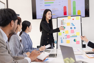 Group of business people working together with dashboard analysis and data management a meeting table in an office.