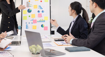 Group of business people working together with dashboard analysis and data management a meeting table in an office.
